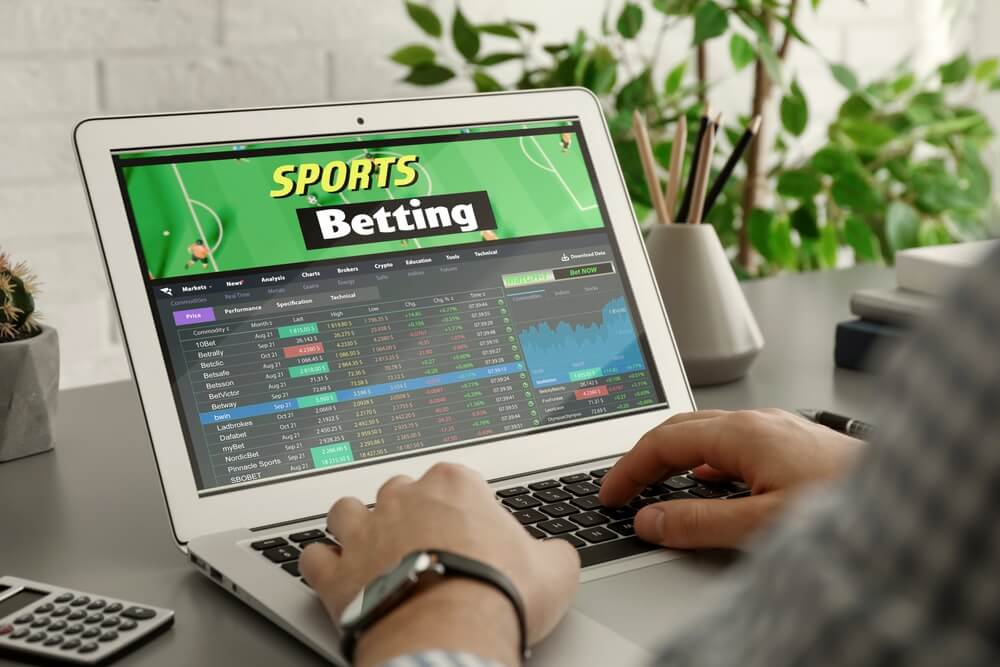 Man,Betting,On,Sports,Using,Laptop,At,Table,,Closeup.,Bookmaker