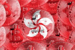 Holding,A,Physical,Version,Of,Bitcoin,And,The,Flag,Of