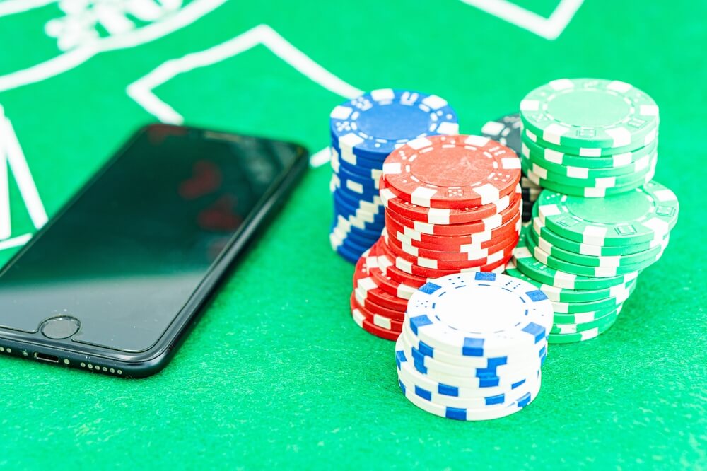 Casino,Chip,And,Phone,On,The,Table,In,Casino,Concept